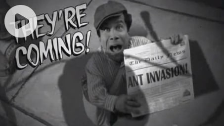 A man holding a newspaper with the words Ant invasion and text saying they're coming.