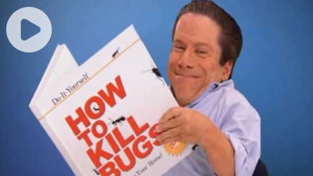 Greg holding a book titled "How to kill bugs."