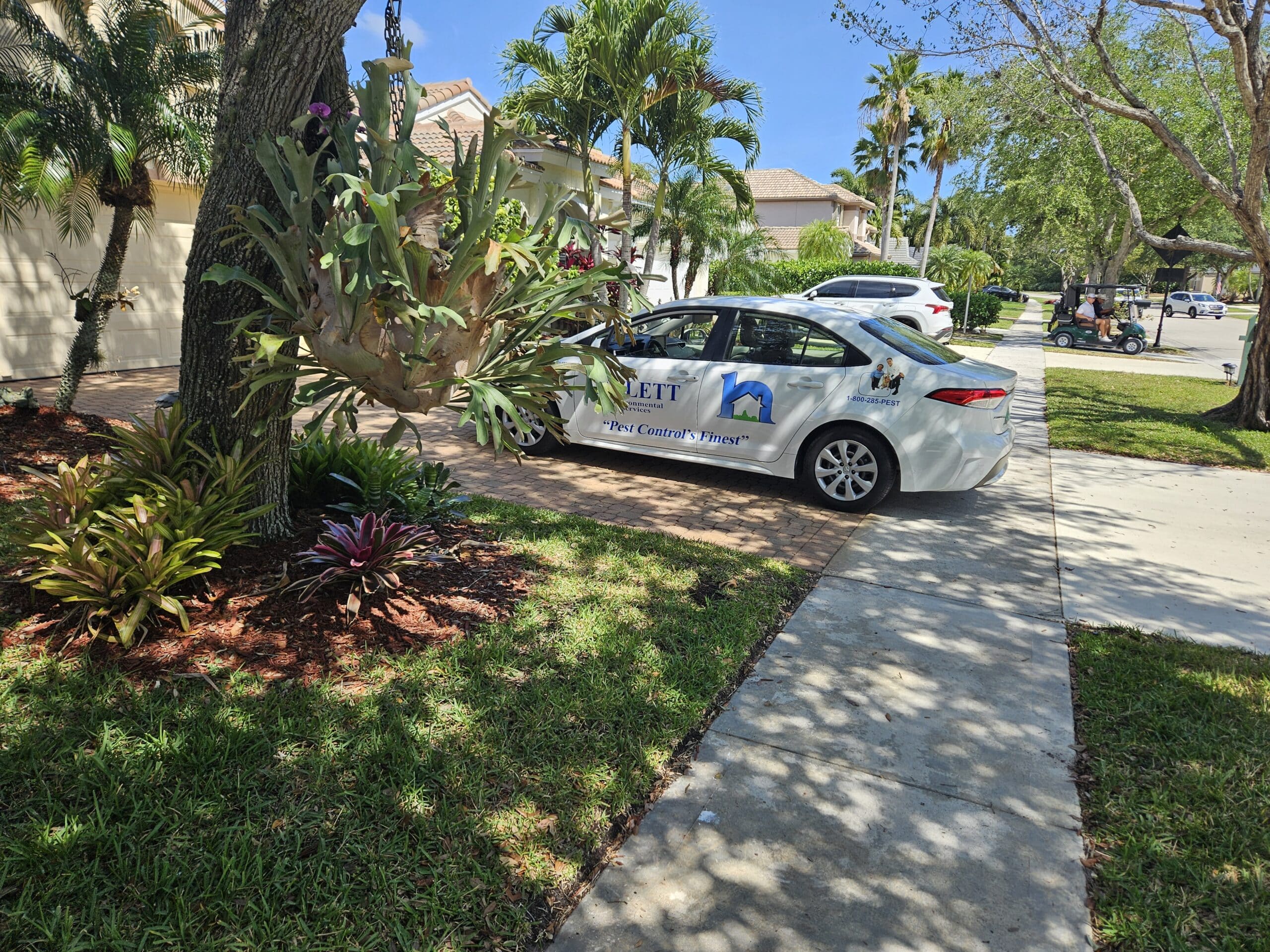 Hulett service car parked in a Port St. Lucie driveway ready to provide pest control services.