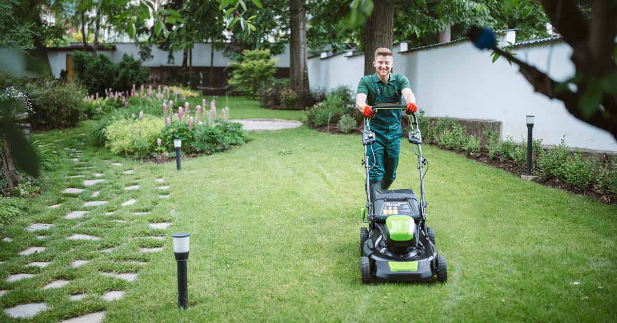 A man mowing his yard.