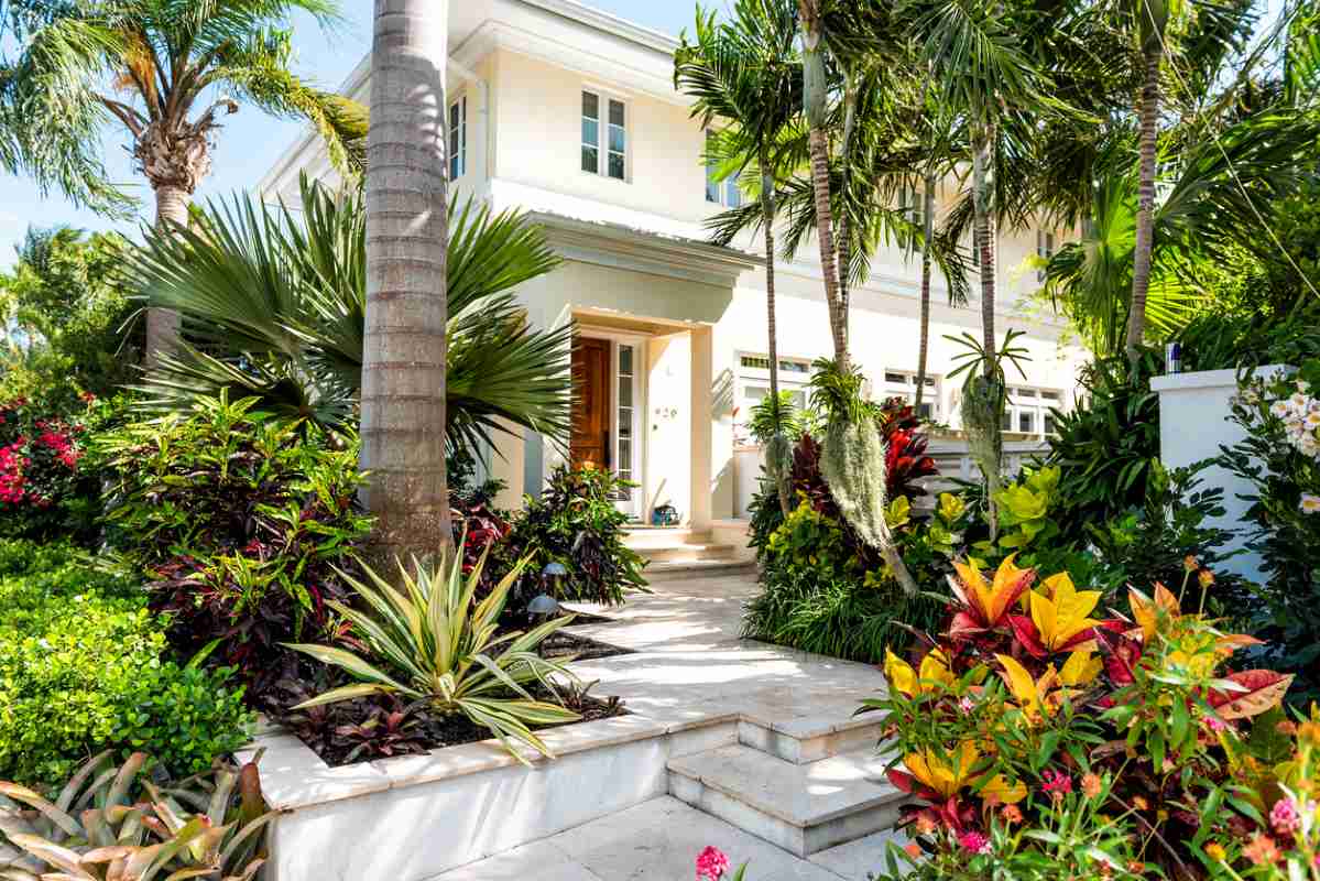 Luxury modern entrance architecture of house in Florida city island on travel, sunny day, property real estate with garden landscaping decoration steps